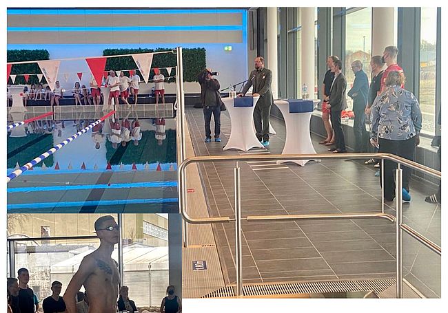 Das Foto zeigt den Innenraum der Schwimmhalle. Im vorgergrund steht Olympiasieger Florian Wellbrock / im Hintergrund spricht Landrat Martin Stichnoth zu den Gästen. 