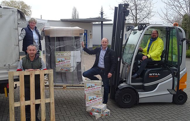 Foto Agrarmarketinggesellschaft Sachsen-Anhalt / die Rohlinge für die "Börde Schatz Kiste" werden in Seehausen (Börde) unter Mithilfe von Landrat Martin Stichnoth entladen. Stichnoth sitzt auf einem Gabelstapler.