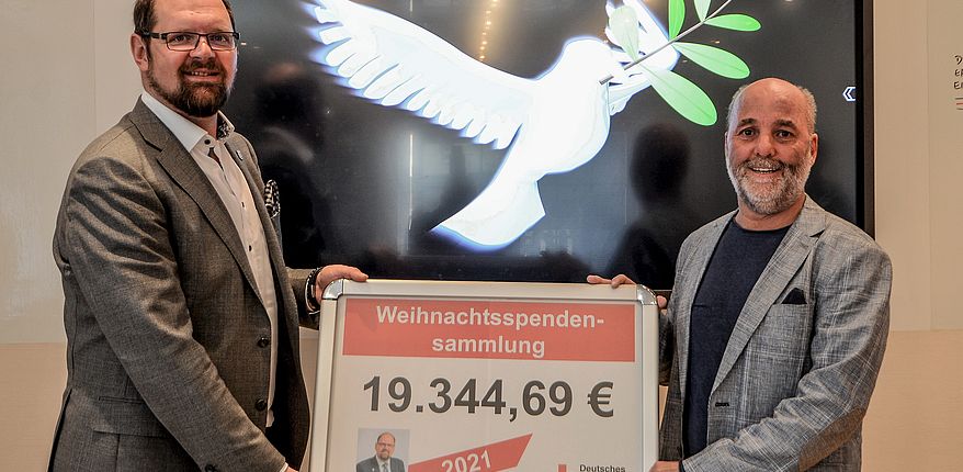 Das Foto ist von Hagen Uhlenhaut. Es zeigt Landrat Martin Stichnoth und Torsten Winkelmann (rechts im Bild), Vorstandsvorsitzender des DRK-Kreisverbandes Wanzleben bei der öffentlichen Präsentation des Ergebnisses der letzten Weihnachtsspendensammlung. Beiden halten einen Bildschirm auf dem das Spendenergebnis eingeblendet ist. 